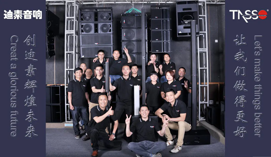 The TASSO team photographed in front of a flown line array rig